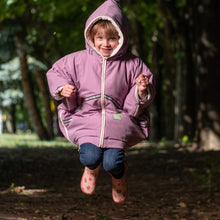 baby parka toddler coat in pink, worn by 5 year old, she is jumping for joy